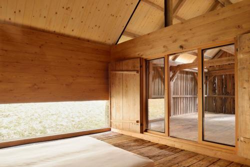 an empty room with wooden walls and wood flooring at Alpine Contrapposto in Solčava