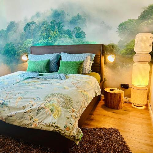a bedroom with a bed with a painting on the wall at Ferienwohnung Piesbach in Nalbach