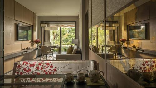 a room with a glass table and a mirror at Four Seasons Hotel Kyoto in Kyoto