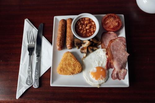 a plate of breakfast food with eggs sausage beans and beans at St James Hotel in Grimsby