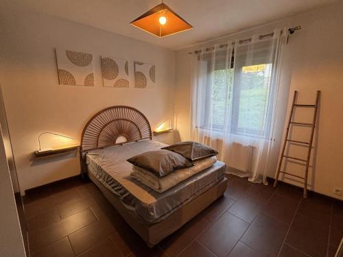 a bedroom with a large bed with a large window at Gite d'arnaud & emilie in Laifour