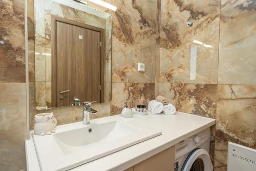 a bathroom with a sink and a mirror at Maera Apartments in Sami