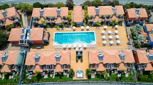 an aerial view of a building with a swimming pool at Caybeach Meloneras in Meloneras
