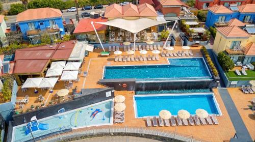 an aerial view of a resort with a swimming pool at Caybeach Meloneras in Meloneras