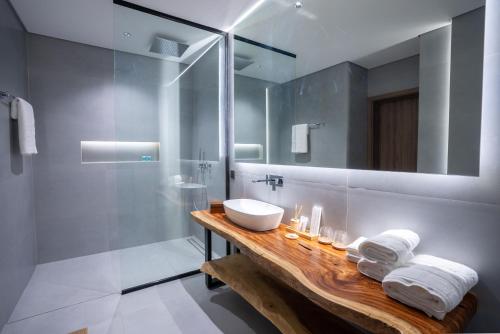 a bathroom with a sink and a shower at The Reef Villa in Bahlāʼ