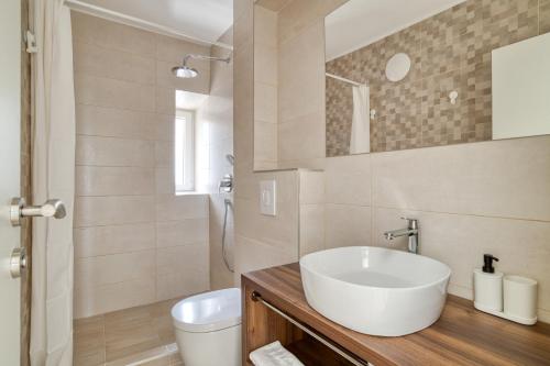 a bathroom with a sink and a toilet at SM Beach Residence in Petrovac na Moru