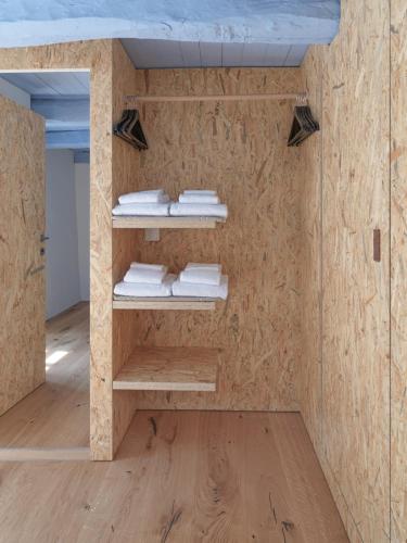 a room with wooden walls and shelves with towels at Corippo Albergo Diffuso in Corippo