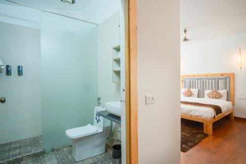 a bathroom with a sink and a bed in a room at Wildernest Resort in Kota Bāgh
