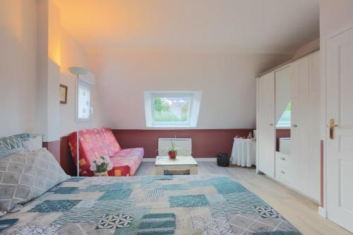 a bedroom with a bed and a couch at Chambres D'hôtes Soizic in Paimpol