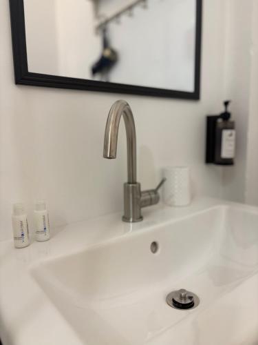 a sink in a bathroom with a mirror above it at Alla Pergola in Ceniga