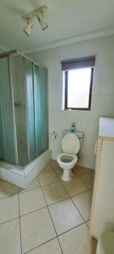 a bathroom with a toilet and a glass shower at Rivers Rest in Seafield
