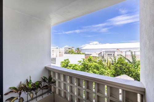 a balcony with a view of the city at Pyramid Ateliero Hotel Canggu in Canggu