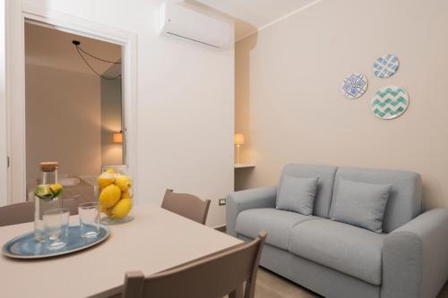 a living room with a table and a couch at Zest House Pompei in Pompei