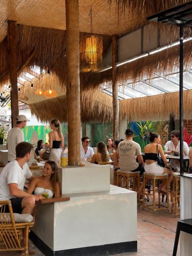 a group of people sitting at tables in a restaurant at Noahs Ark in Lamai
