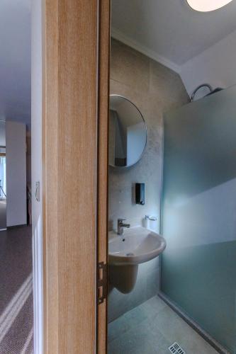 a bathroom with a sink and a mirror at Family Hotel Deja Vu in Ravda