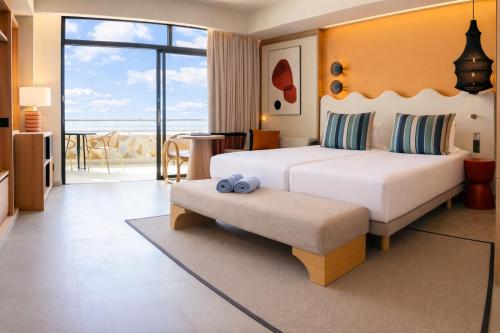 a hotel room with a bed and a balcony at Gloria Palace Amadores Thalasso & Hotel in Puerto Rico de Gran Canaria