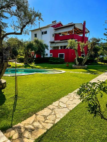 a house with a yard with a swimming pool at Poly's Villa Lefkada in Lefkada