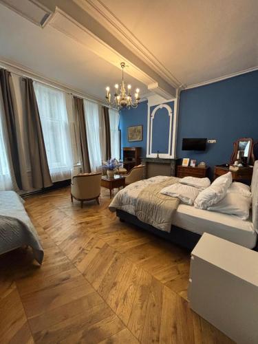a bedroom with a large bed and a blue wall at Experiencebruges in Bruges
