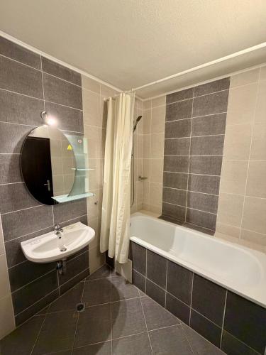 a bathroom with a sink and a bath tub at Hotel Amaris in Sunny Beach