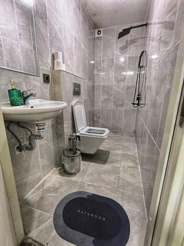 a bathroom with a toilet and a sink at GRAND BELLA VİSTA Hostel in Istanbul