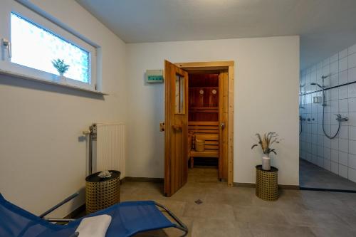 a bathroom with a shower and a door with a window at Johouse Zingst Johouse Zimmer 01 in Zingst
