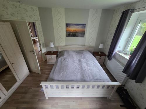a bedroom with a large white bed in a room at Haus Küstenheide in Cuxhaven