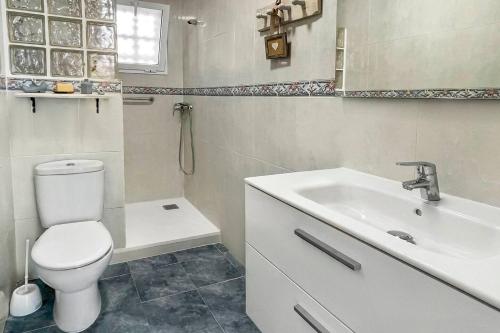a bathroom with a white toilet and a sink at Azul. Cómodo, bonito y céntrico in Calpe