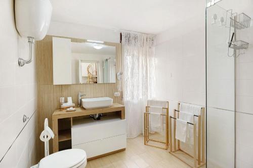 a bathroom with a toilet and a sink and a mirror at Angel's House in Sarno