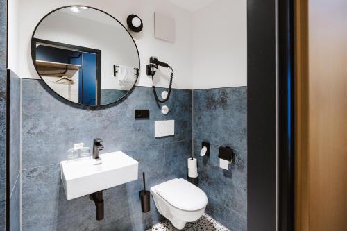 a bathroom with a sink and a mirror at Hostel SLEPS in Augsburg