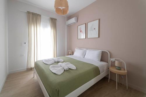 a bedroom with a bed with a bow on it at Mea Casa Comfort Home in Pitsidia