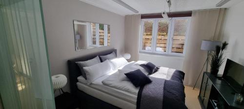 a bedroom with a bed with white sheets and pillows at zeitlang by angelika kodewitz in Waldsassen