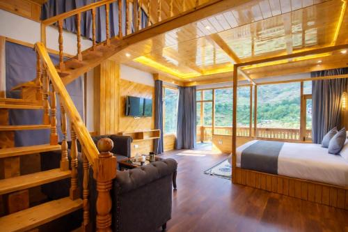 a bedroom with a bed and a staircase at Regal Retreat Inn in Shirir