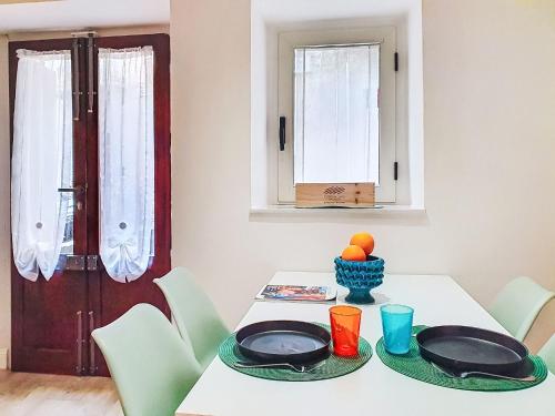 a dining room table with two plates on top of it at Apartment Studio Kalè Akté by Interhome in Caronia