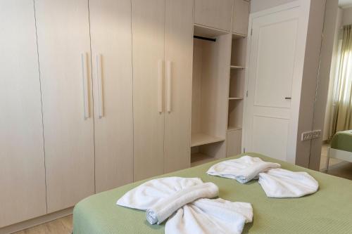 two towels sitting on a bed in a room at Mea Casa Comfort Home in Pitsidia