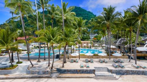 a view of the pool at a resort with palm trees at OUTRIGGER Koh Samui Beach Resort in Lamai
