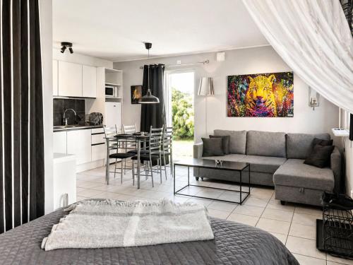a living room and kitchen with a couch and a table at Apartment Brömsebro by Interhome in Halmstad