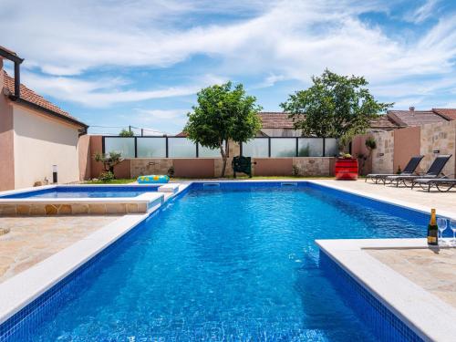 a swimming pool with blue water in a house at Holiday Home Šimić by Interhome in Dušić
