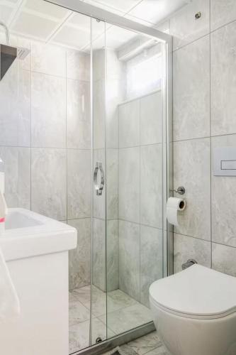 a bathroom with a shower and a toilet and a sink at Güneş Villa Bahçe Katı in Antalya