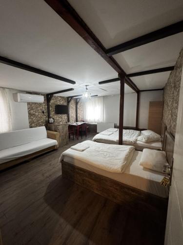 a large bedroom with two beds and a table at Cağaloğlu Apart Butik Otel in Atakum