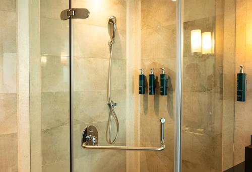 a shower in a bathroom with a glass door at DoubleTree by Hilton-Pune Chinchwad in Pune