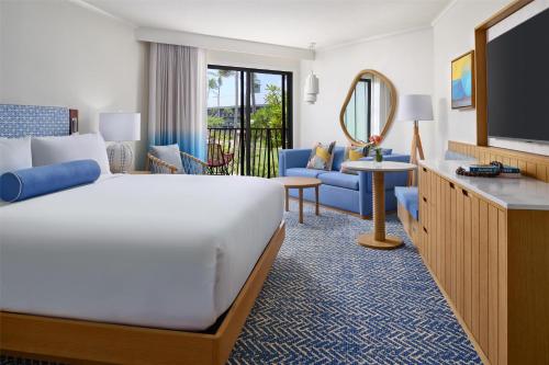 a hotel room with a bed and a television at OUTRIGGER Kaua'i Beach Resort & Spa in Lihue