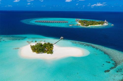 an island in the maldives with a resort on it at OUTRIGGER Maldives Maafushivaru Resort in Dhangethi