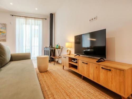 a living room with a large flat screen tv at Apartment Edificio Candela-1 by Interhome in L'Ametlla de Mar