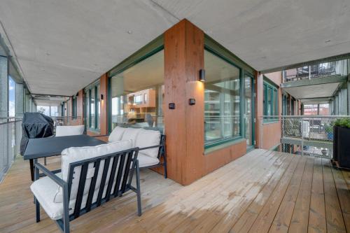 a room with a bench and a table on a deck at Modern Apartment in Ski in Siggerud