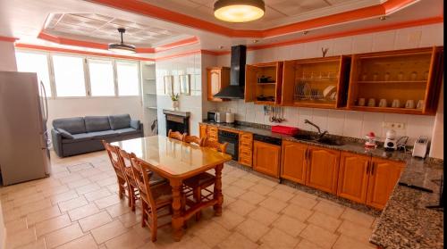 a kitchen with a wooden table and a dining room at Ruralux Sierra Castril in Huéscar