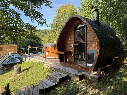 a small log cabin with a wooden deck at Chalet Cozy Bear Cabin by Interhome in Mrkopalj