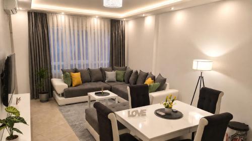 a living room with a couch and a table at Luxury Apartment Paraćin - River View in Paraćin