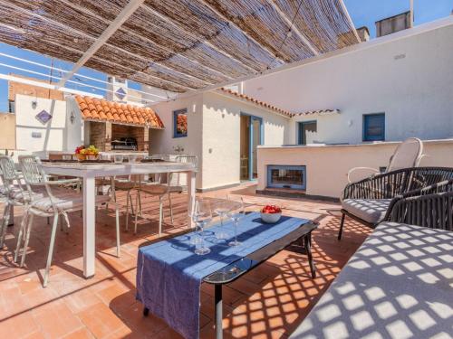 a patio with a table and chairs and a fireplace at Apartment Edificio Candela-2 by Interhome in L'Ametlla de Mar