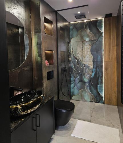 a bathroom with a black toilet and a shower at Królowa Beskidu in Słopnice