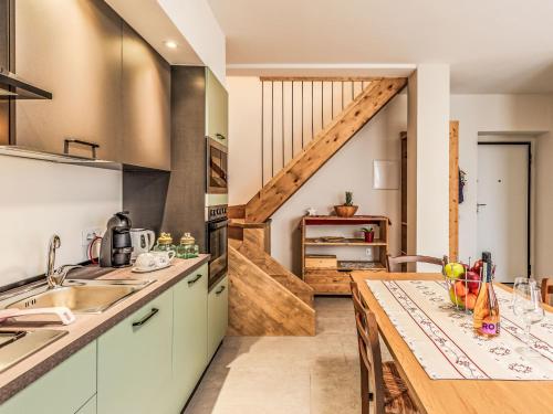 a kitchen with a counter top and a table at Holiday Home Mimi by Interhome in Verceia